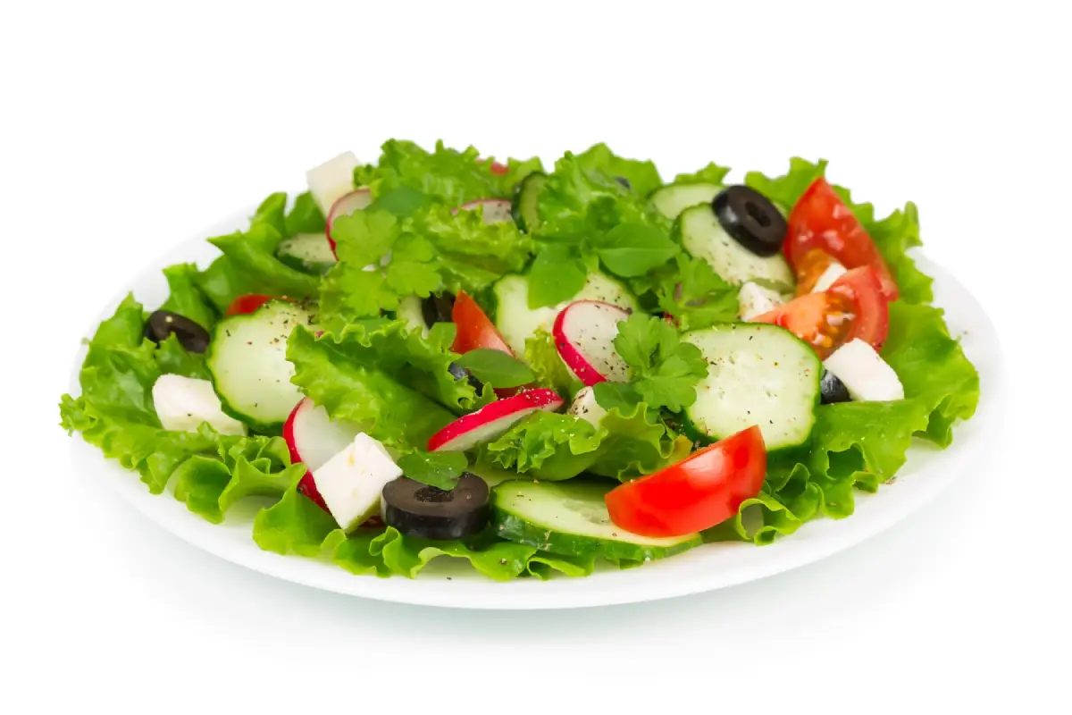Freshly prepared Tomato Cucumber Radish Salad with black olives and feta cheese. 