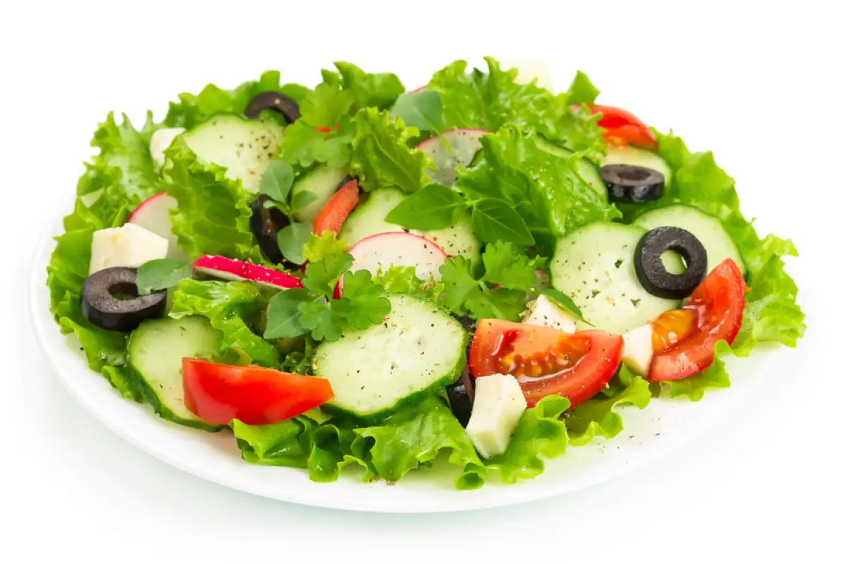 Bright and fresh Tomato Cucumber Radish Salad on a white plate.