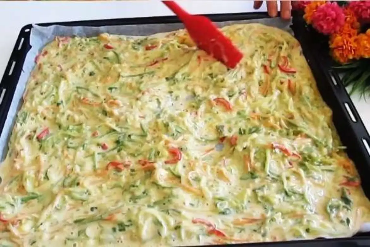 Unbaked Easy Cheesy Zucchini Bake in a tray, garnished and ready for the oven.